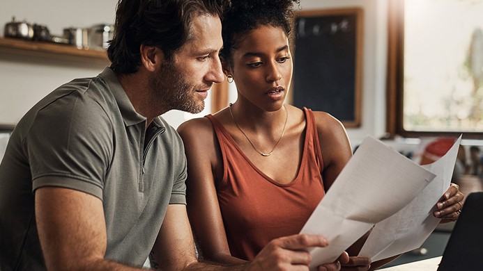 Two people reviewing financial documents